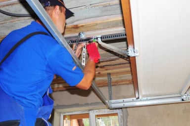 Technician installing a garage door mechanism