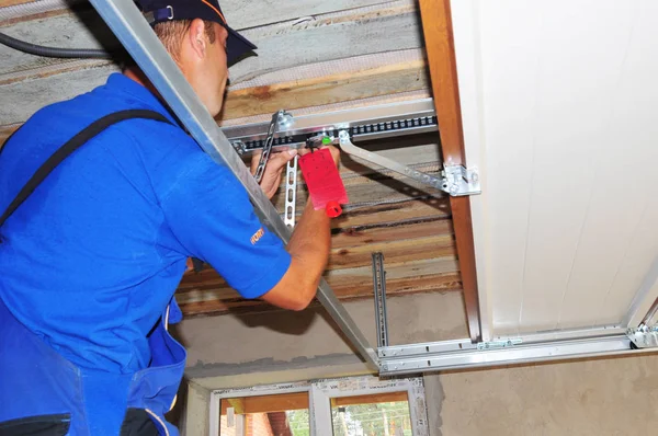 Technician installing a garage door mechanism