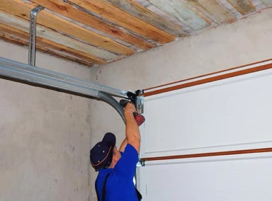 Man repairing a garage door mechanism